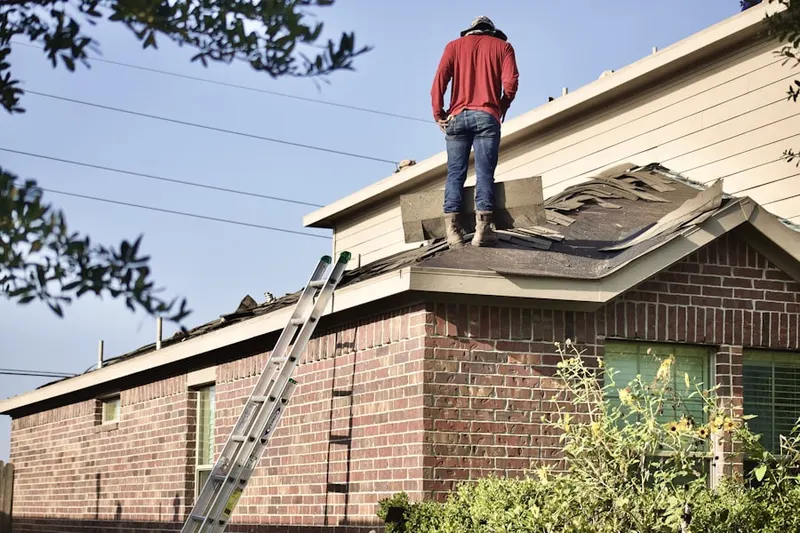 Professional roofer working on a residential roof in East Grove